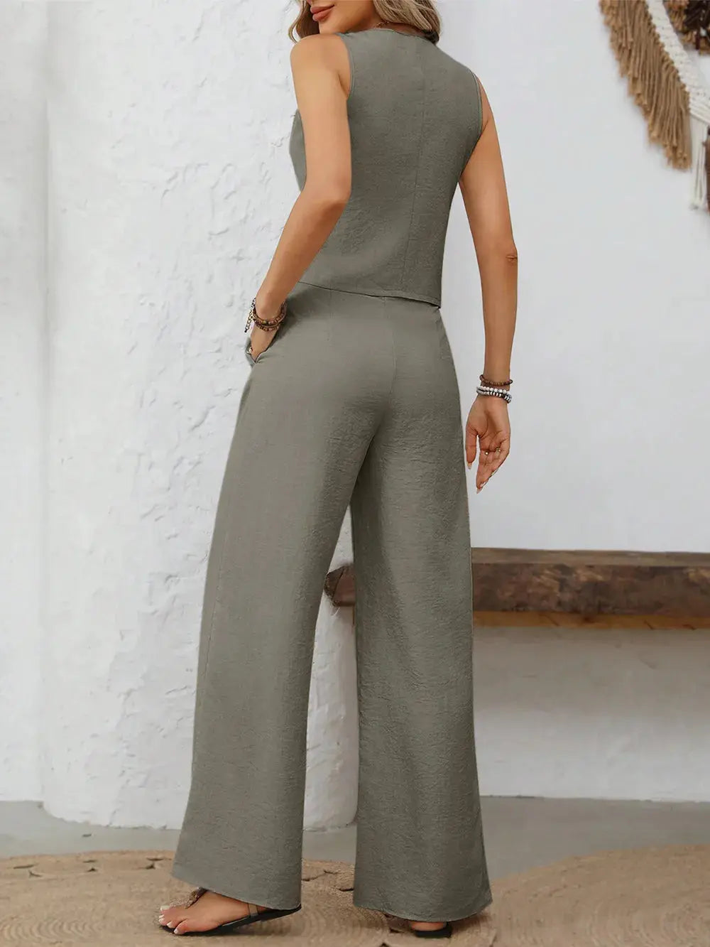 Crafted in versatile shades like beige, slate gray, and soft blue, this ensemble invites endless styling possibilities. Whether layered over a crisp white shirt or styled solo for a minimalist mood, each piece adds depth to your wardrobe staples. The high-waisted pants elongate the frame, while their gentle drape moves gracefully with every step.