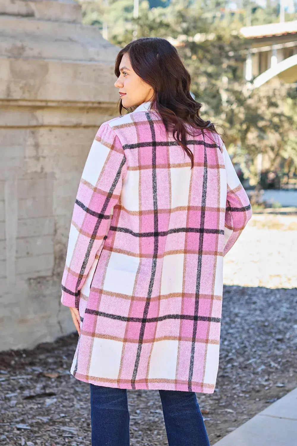 Wrap yourself in cozy charm with this Pink Plaid Button-Up Coat—a statement layer that blends warmth with playful sophistication. Designed in a soft checkered weave of blush, ivory, and brown, this midweight coat features a relaxed fit that’s perfect for layering over your everyday essentials. Classic button-front detailing and side pockets offer practicality, while the longline silhouette adds a modern, polished finish. Whether you're strolling downtown or escaping to a weekend cabin, this piece brings tex