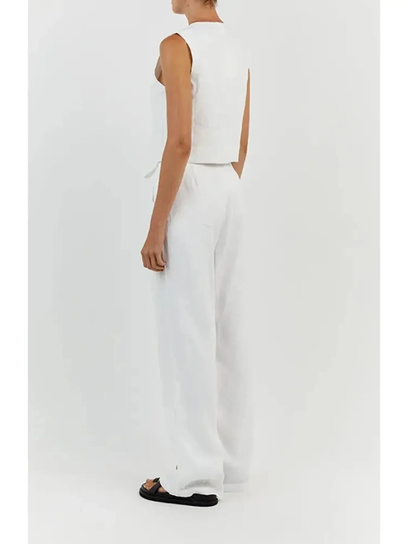 Functional pockets enhance convenience while lending the outfit a utilitarian charm. The top features a modest crop that pairs effortlessly with high-waisted bottoms, while the straight-leg pants offer ease through the hips and thighs. Available in sizes XS to 3XL, the set includes detailed measurements—waist starting at 23.2", bust from 32.3", and full bottom length up to 41.3"—to ensure a personalized fit.