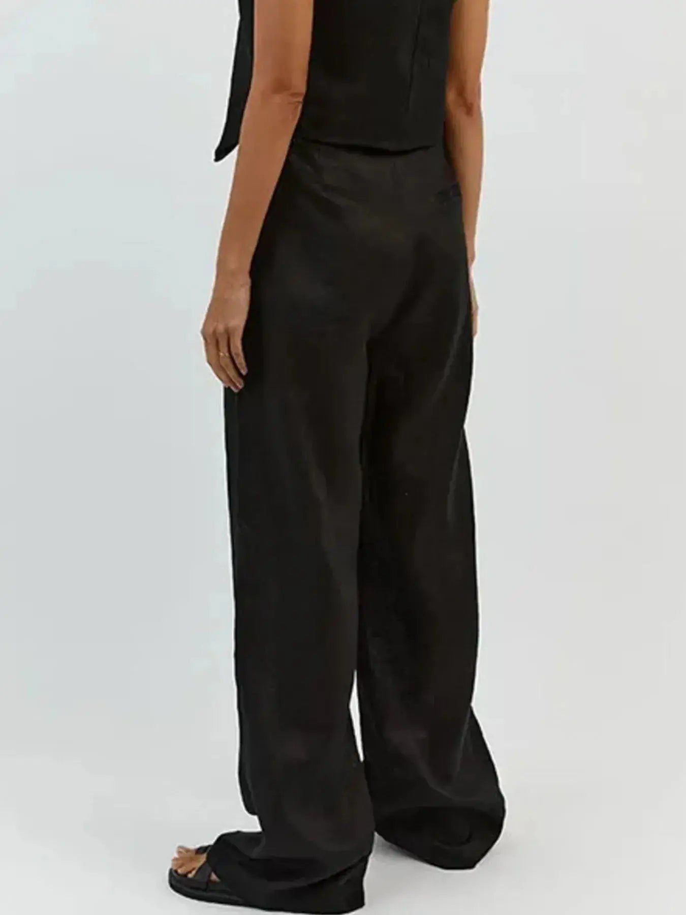 Functional pockets enhance convenience while lending the outfit a utilitarian charm. The top features a modest crop that pairs effortlessly with high-waisted bottoms, while the straight-leg pants offer ease through the hips and thighs. Available in sizes XS to 3XL, the set includes detailed measurements—waist starting at 23.2", bust from 32.3", and full bottom length up to 41.3"—to ensure a personalized fit.