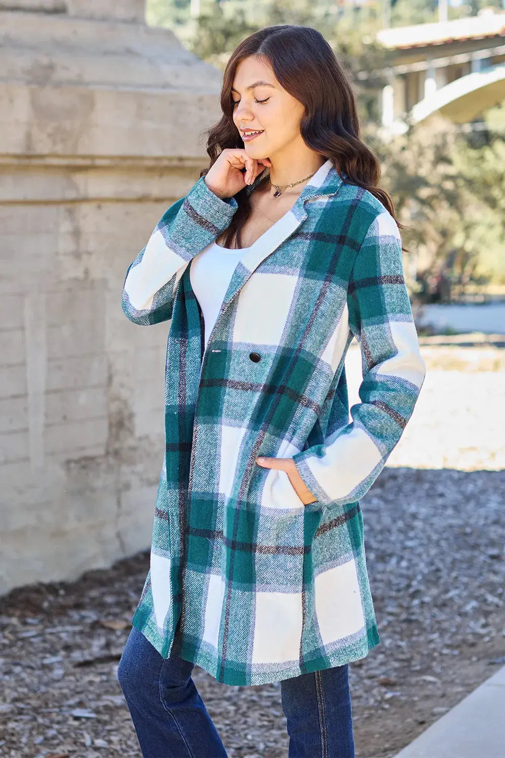 Wrap yourself in cozy charm with this Pink Plaid Button-Up Coat—a statement layer that blends warmth with playful sophistication. Designed in a soft checkered weave of blush, ivory, and brown, this midweight coat features a relaxed fit that’s perfect for layering over your everyday essentials. Classic button-front detailing and side pockets offer practicality, while the longline silhouette adds a modern, polished finish. Whether you're strolling downtown or escaping to a weekend cabin, this piece brings tex
