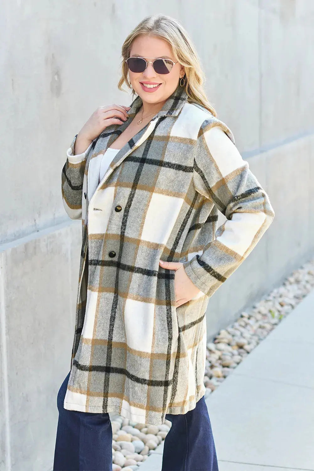 Wrap yourself in cozy charm with this Pink Plaid Button-Up Coat—a statement layer that blends warmth with playful sophistication. Designed in a soft checkered weave of blush, ivory, and brown, this midweight coat features a relaxed fit that’s perfect for layering over your everyday essentials. Classic button-front detailing and side pockets offer practicality, while the longline silhouette adds a modern, polished finish. Whether you're strolling downtown or escaping to a weekend cabin, this piece brings tex