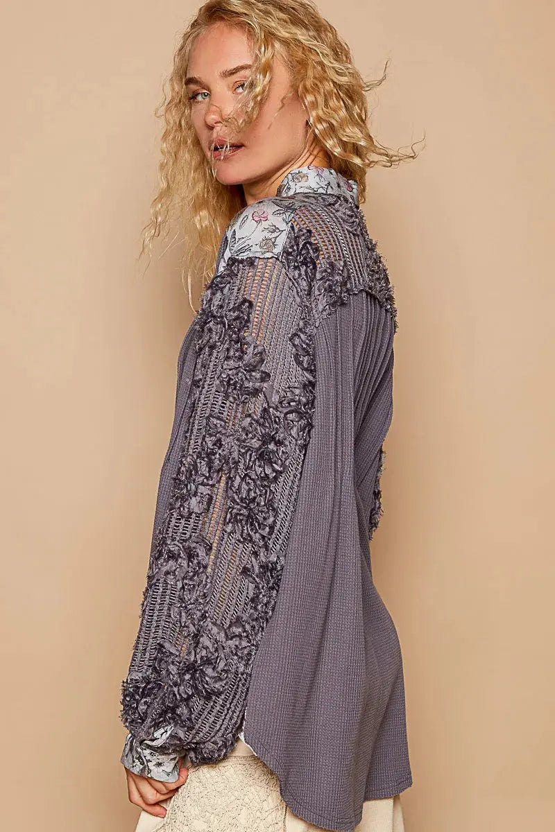 This beautiful blouse features a floral print and delicate lace detailing for a feminine touch. The half-button design adds a stylish and versatile element to the top. With long sleeves, this blouse is perfect for adding a touch of elegance to your outfit while keeping you warm. Elevate your wardrobe with this chic and romantic piece.