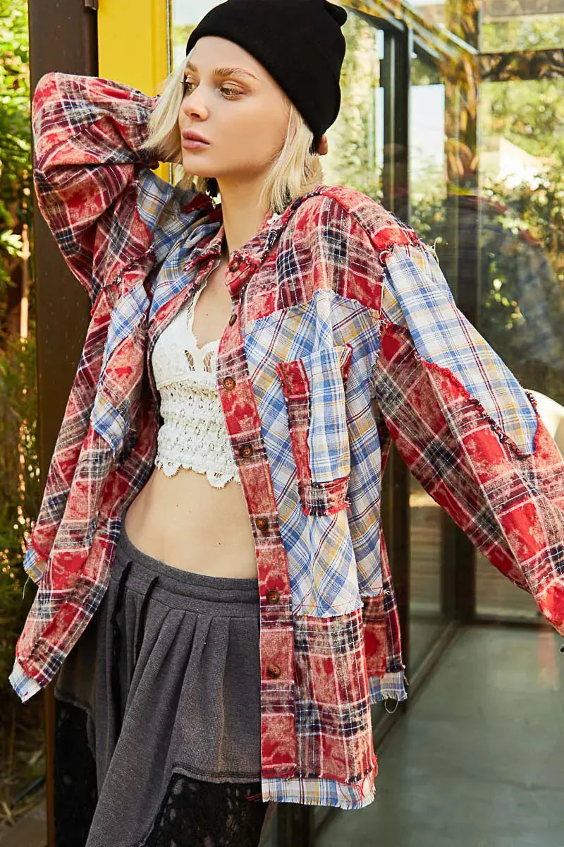 This long sleeve shirt showcases a stylish plaid patchwork design with raw edge detailing for a trendy and edgy look. The combination of prints adds visual interest and dimension to the shirt. Perfect for adding a touch of casual-cool to your outfit, this shirt is a statement piece. Stay on-trend with this unique and versatile addition to your wardrobe.