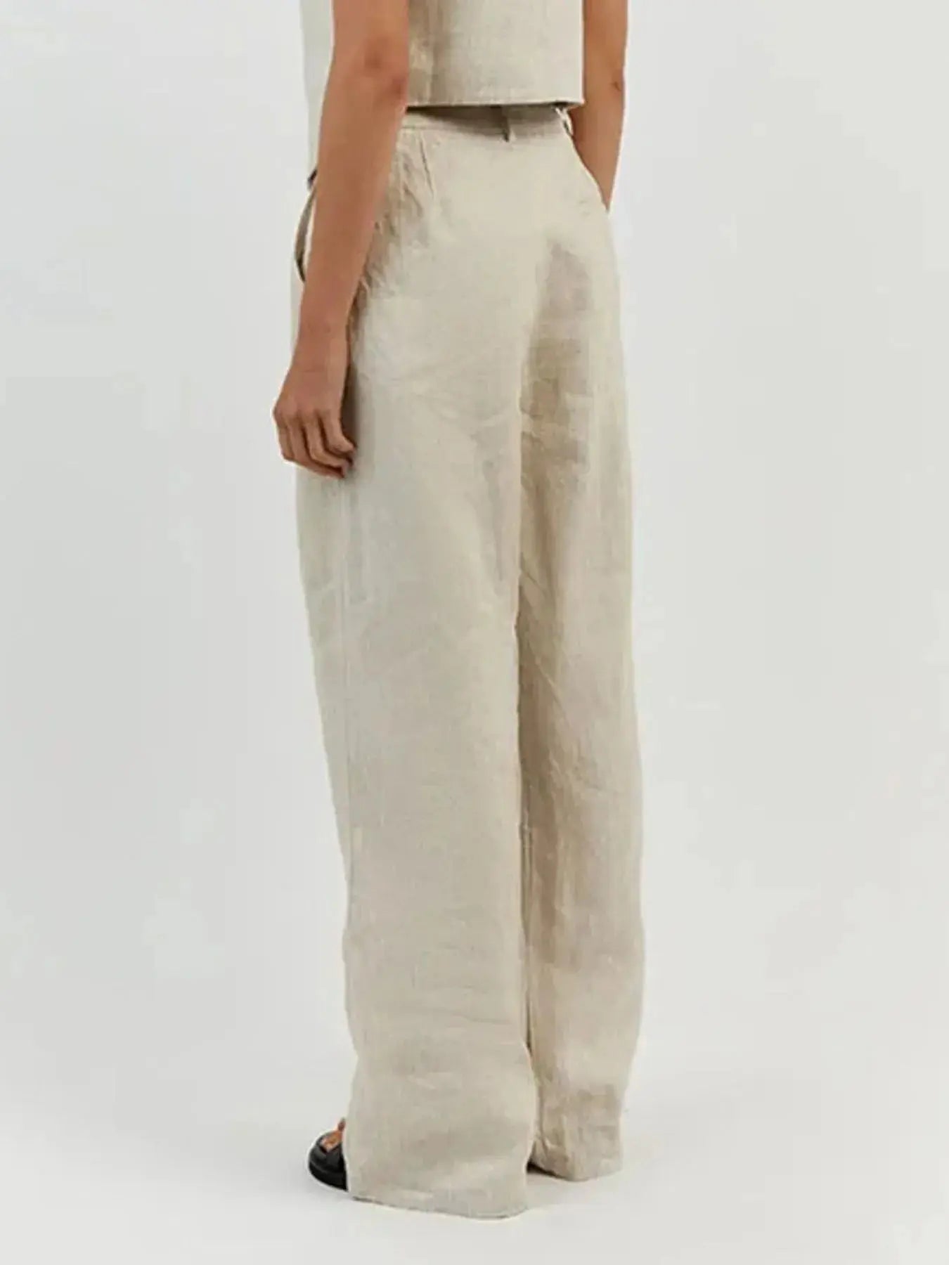 Functional pockets enhance convenience while lending the outfit a utilitarian charm. The top features a modest crop that pairs effortlessly with high-waisted bottoms, while the straight-leg pants offer ease through the hips and thighs. Available in sizes XS to 3XL, the set includes detailed measurements—waist starting at 23.2", bust from 32.3", and full bottom length up to 41.3"—to ensure a personalized fit.