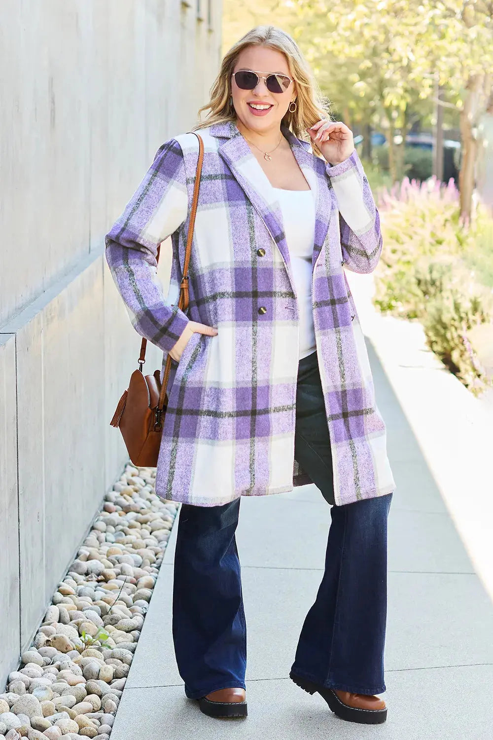 Wrap yourself in cozy charm with this Pink Plaid Button-Up Coat—a statement layer that blends warmth with playful sophistication. Designed in a soft checkered weave of blush, ivory, and brown, this midweight coat features a relaxed fit that’s perfect for layering over your everyday essentials. Classic button-front detailing and side pockets offer practicality, while the longline silhouette adds a modern, polished finish. Whether you're strolling downtown or escaping to a weekend cabin, this piece brings tex