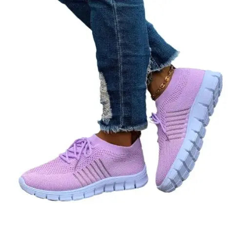 Model wearing a lilac pair of the Breathable Mesh Round Toe Sneakers