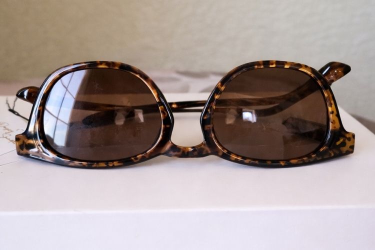 Tortoiseshell sunglasses with brown lenses on a light surface