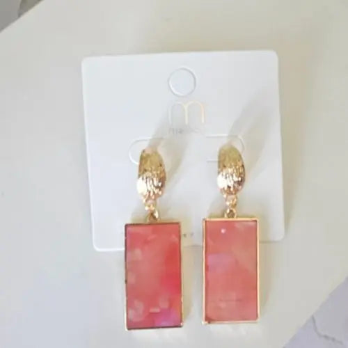 Elevate your accessory game with these Blush Marbled Drop Earrings, where soft femininity meets modern edge. Designed with a unique blend of blush-toned marbled resin and textured gold-tone hoops, these earrings strike the perfect balance between elegance and boldness. The lightweight construction ensures all-day comfort, while the secure post-back closure keeps them in place from morning meetings to evening cocktails.