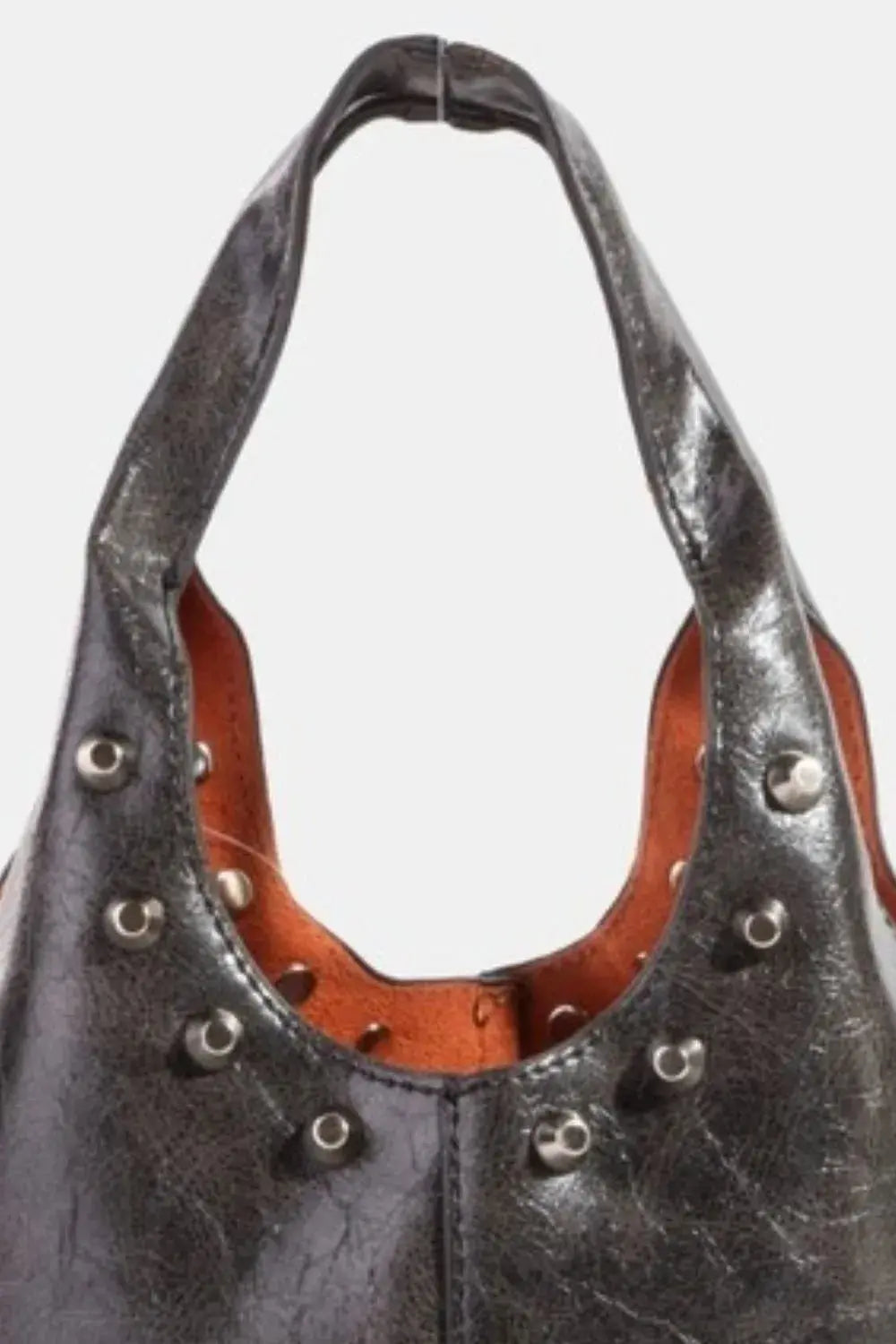 A close-up of a black faux leather handbag with studs on a white background.