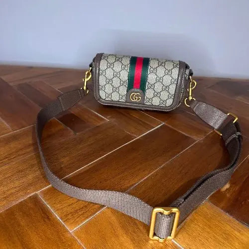 Elevate your accessory collection with this sophisticated designer-inspired crossbody bag. Featuring an elegant monogram print that exudes timeless style, this high-quality bag combines functionality with fashion-forward design. Perfect for everyday wear, it offers convenient hands-free carrying while making a refined statement.