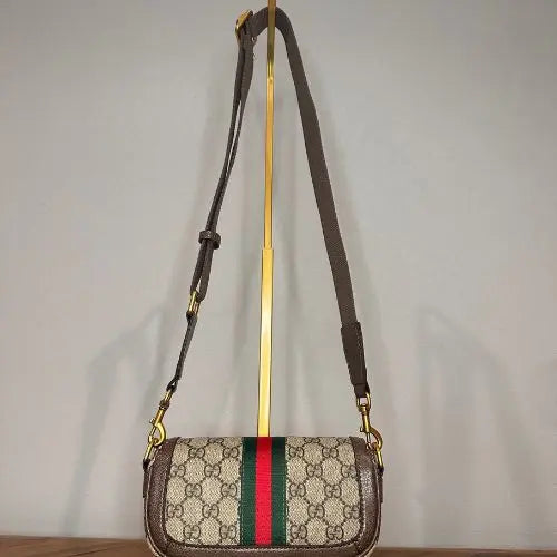 Elevate your accessory collection with this sophisticated designer-inspired crossbody bag. Featuring an elegant monogram print that exudes timeless style, this high-quality bag combines functionality with fashion-forward design. Perfect for everyday wear, it offers convenient hands-free carrying while making a refined statement.