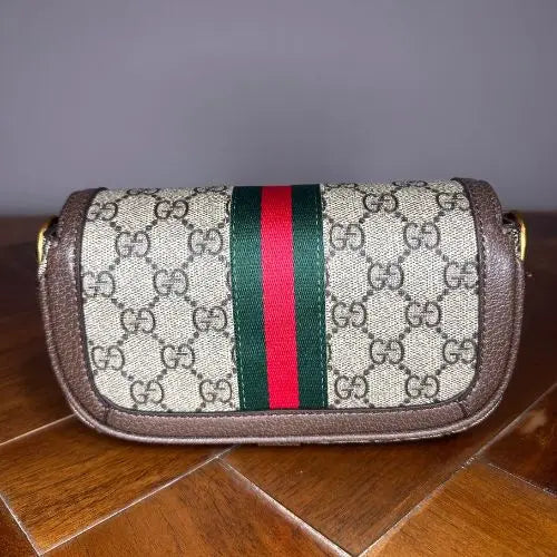 Elevate your accessory collection with this sophisticated designer-inspired crossbody bag. Featuring an elegant monogram print that exudes timeless style, this high-quality bag combines functionality with fashion-forward design. Perfect for everyday wear, it offers convenient hands-free carrying while making a refined statement.