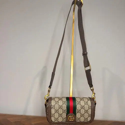 Elevate your accessory collection with this sophisticated designer-inspired crossbody bag. Featuring an elegant monogram print that exudes timeless style, this high-quality bag combines functionality with fashion-forward design. Perfect for everyday wear, it offers convenient hands-free carrying while making a refined statement.