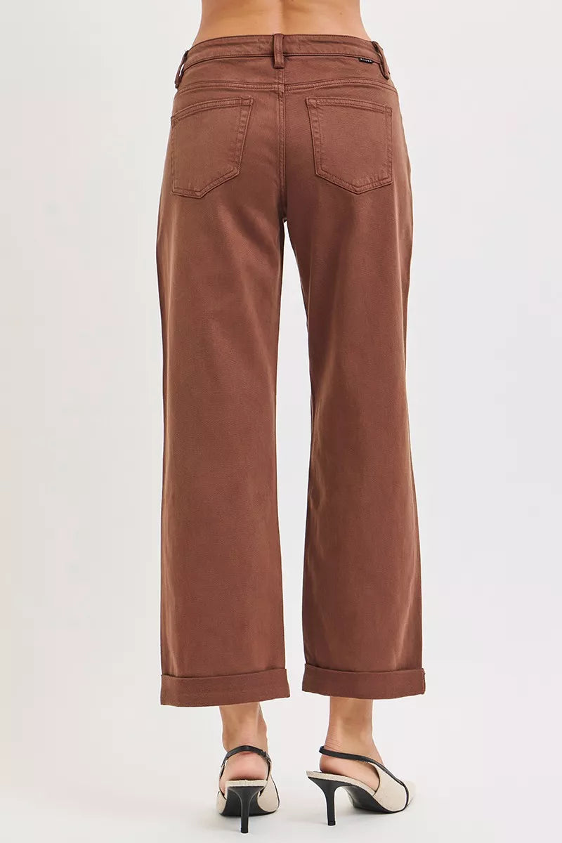 Brown pants worn by a person on a white background
