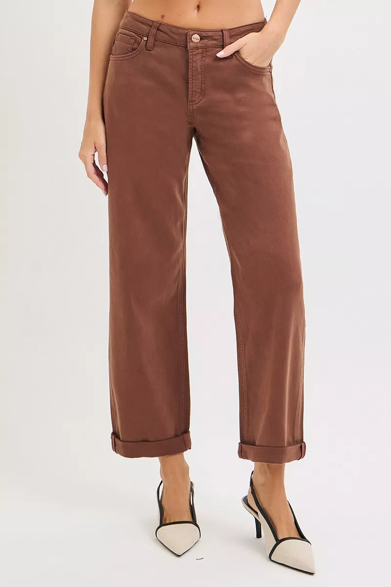 Brown pants worn by a person on a white background