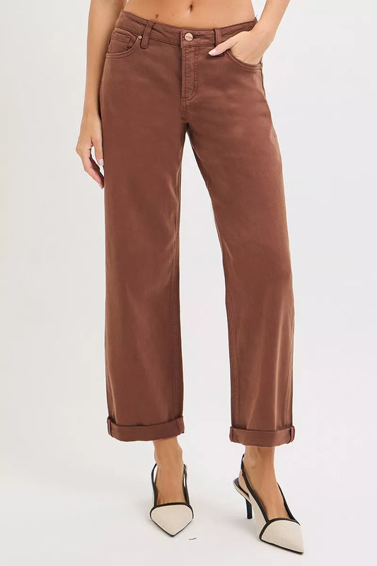 Brown pants worn by a person on a white background