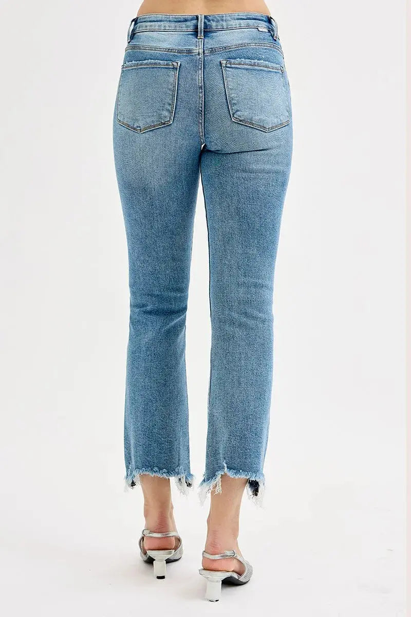 The back view of a person wearing light blue jeans worn by a person on a white background.