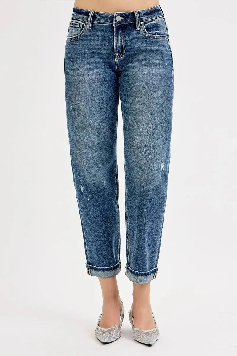 Cropped blue jeans with a slight fade on a white background
