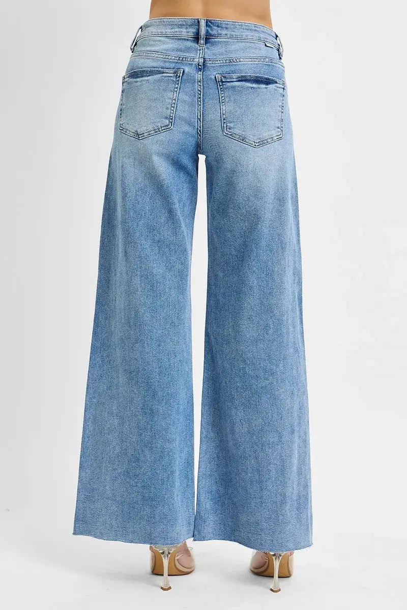 The back of light blue wide-leg jeans on a white background