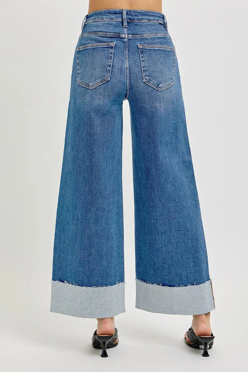 The back view of blue wide-leg cuffed jeans on a white background