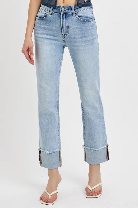 Light blue jeans with rolled-up cuffs on a white background