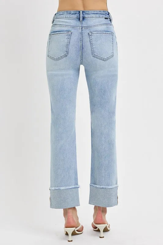 The back of light blue jeans worn by a person on a white background