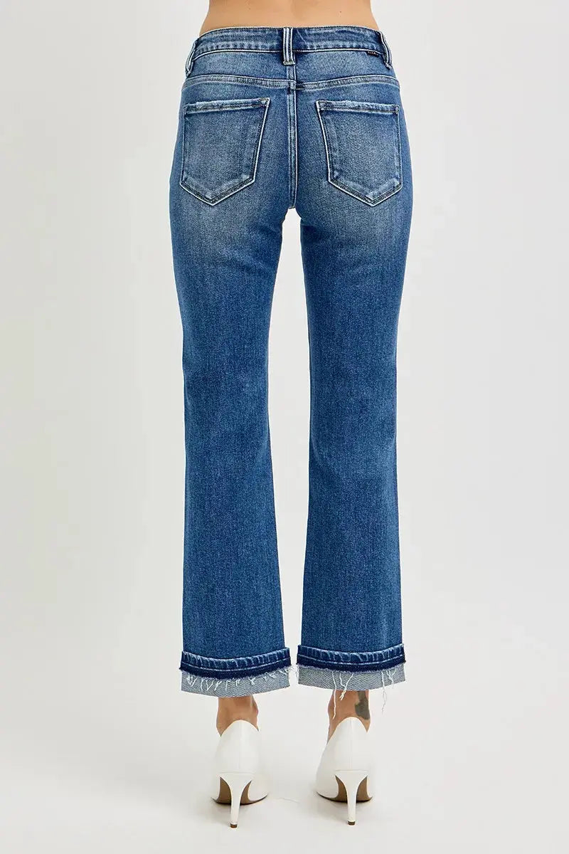 The back view of blue jeans worn by a person on a white background