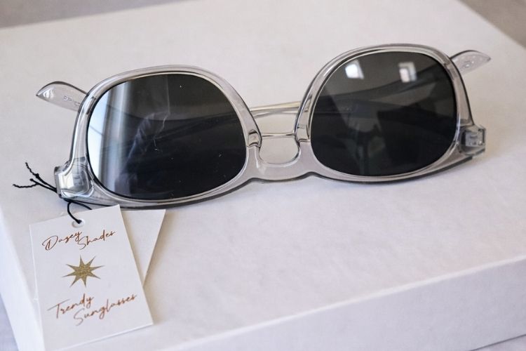 Sunglasses with a tag on a white surface