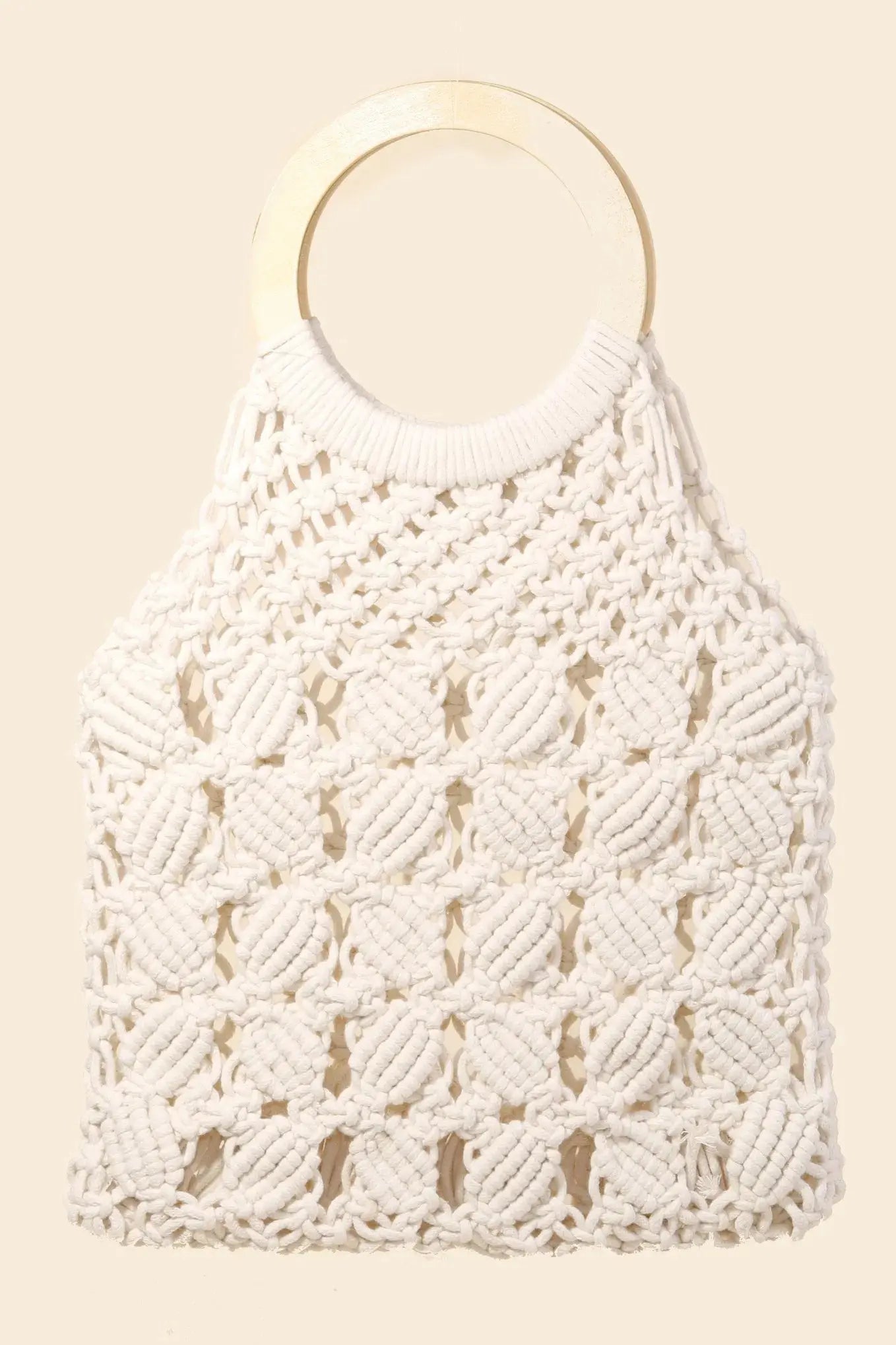 White macrame bag with a white wooden handle on a beige background.