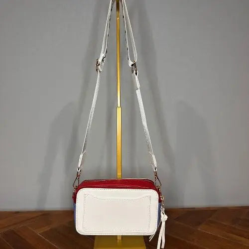 Channel the iconic style of Marc Jacobs with this Snapshot-inspired crossbody—a compact, structured silhouette that blends bold design with everyday function. Crafted from smooth faux leather, it features a dual-zip top closure and a color block palette that adds instant personality to any outfit.