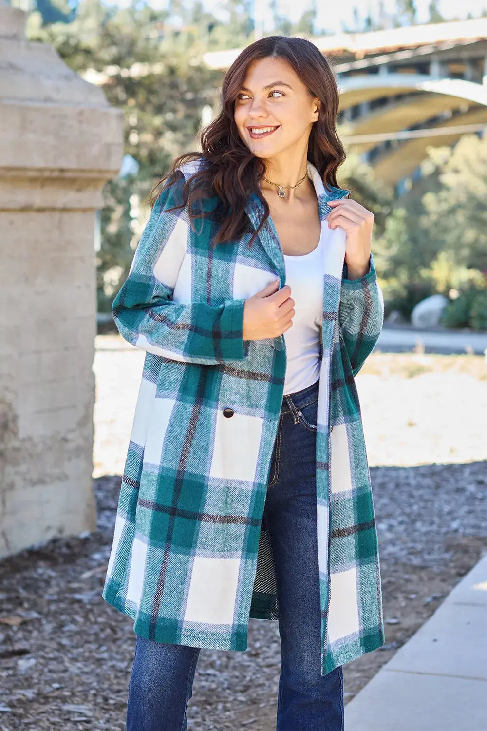 Wrap yourself in cozy charm with this Pink Plaid Button-Up Coat—a statement layer that blends warmth with playful sophistication. Designed in a soft checkered weave of blush, ivory, and brown, this midweight coat features a relaxed fit that’s perfect for layering over your everyday essentials. Classic button-front detailing and side pockets offer practicality, while the longline silhouette adds a modern, polished finish. Whether you're strolling downtown or escaping to a weekend cabin, this piece brings tex