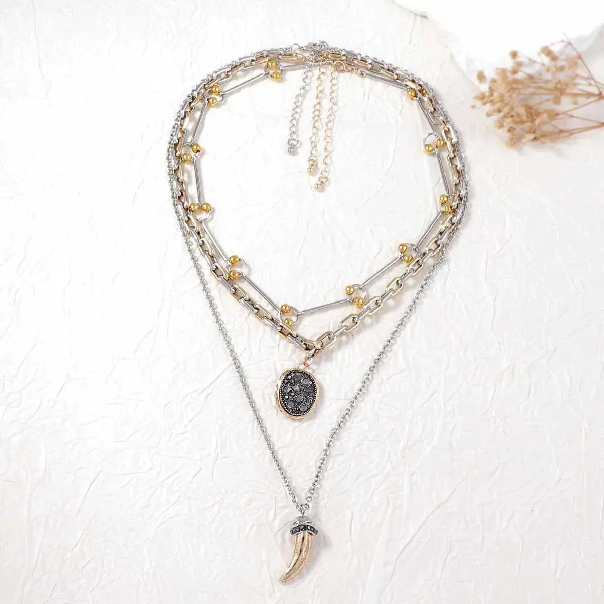 Crafted from 18K gold-plated stainless steel, these necklaces resist corrosion and tarnish with proper care. Ranging from 13.8" to 15.7" in length and fitted with extension chains, the set adjusts comfortably at the collarbone, layering easily with open necklines. Avoid moisture and strenuous activity to preserve the gold finish over time.