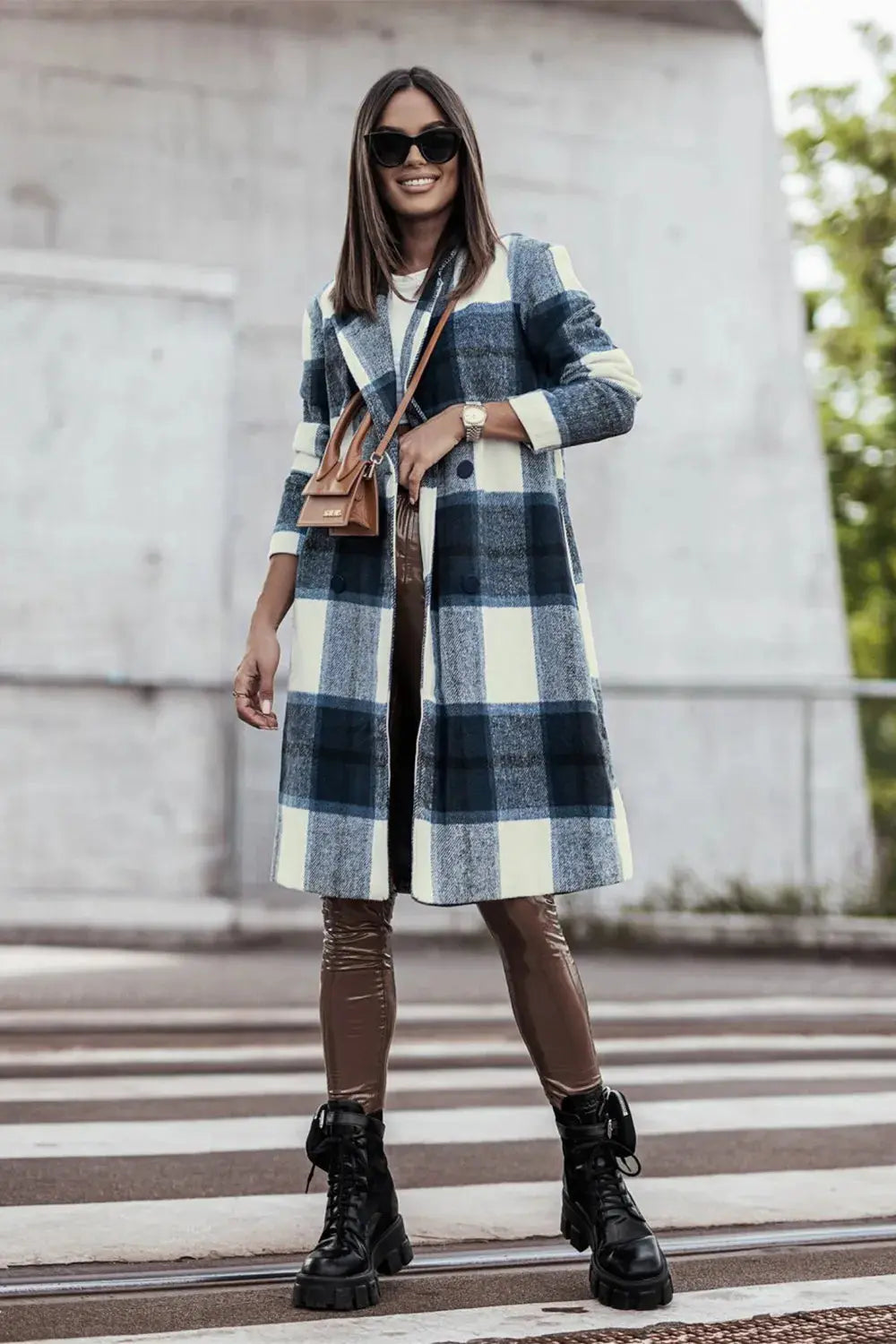 Wrap yourself in cozy charm with this Pink Plaid Button-Up Coat—a statement layer that blends warmth with playful sophistication. Designed in a soft checkered weave of blush, ivory, and brown, this midweight coat features a relaxed fit that’s perfect for layering over your everyday essentials. Classic button-front detailing and side pockets offer practicality, while the longline silhouette adds a modern, polished finish. Whether you're strolling downtown or escaping to a weekend cabin, this piece brings tex