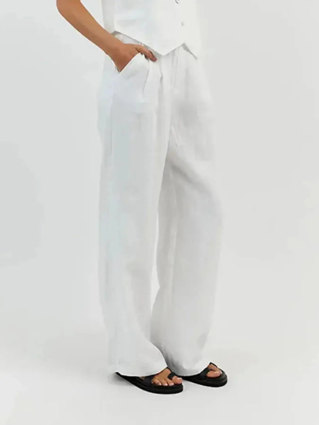 Functional pockets enhance convenience while lending the outfit a utilitarian charm. The top features a modest crop that pairs effortlessly with high-waisted bottoms, while the straight-leg pants offer ease through the hips and thighs. Available in sizes XS to 3XL, the set includes detailed measurements—waist starting at 23.2", bust from 32.3", and full bottom length up to 41.3"—to ensure a personalized fit.