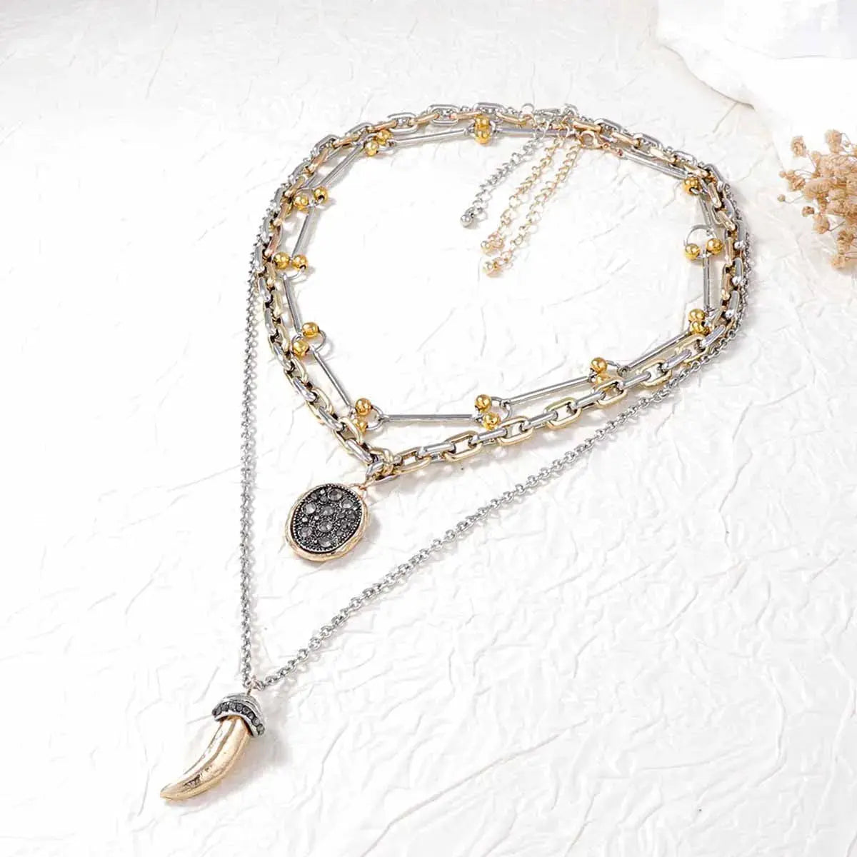 Crafted from 18K gold-plated stainless steel, these necklaces resist corrosion and tarnish with proper care. Ranging from 13.8" to 15.7" in length and fitted with extension chains, the set adjusts comfortably at the collarbone, layering easily with open necklines. Avoid moisture and strenuous activity to preserve the gold finish over time.