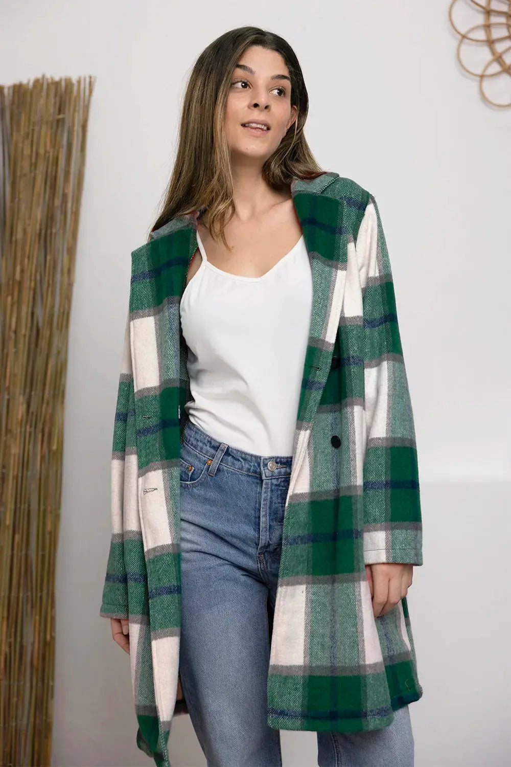 Wrap yourself in cozy charm with this Pink Plaid Button-Up Coat—a statement layer that blends warmth with playful sophistication. Designed in a soft checkered weave of blush, ivory, and brown, this midweight coat features a relaxed fit that’s perfect for layering over your everyday essentials. Classic button-front detailing and side pockets offer practicality, while the longline silhouette adds a modern, polished finish. Whether you're strolling downtown or escaping to a weekend cabin, this piece brings tex