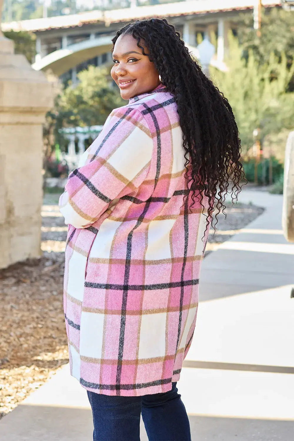 Wrap yourself in cozy charm with this Pink Plaid Button-Up Coat—a statement layer that blends warmth with playful sophistication. Designed in a soft checkered weave of blush, ivory, and brown, this midweight coat features a relaxed fit that’s perfect for layering over your everyday essentials. Classic button-front detailing and side pockets offer practicality, while the longline silhouette adds a modern, polished finish. Whether you're strolling downtown or escaping to a weekend cabin, this piece brings tex