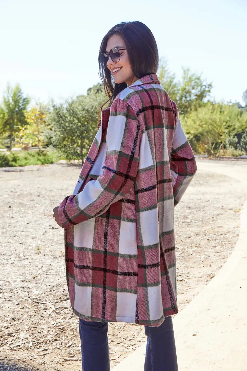 Wrap yourself in cozy charm with this Pink Plaid Button-Up Coat—a statement layer that blends warmth with playful sophistication. Designed in a soft checkered weave of blush, ivory, and brown, this midweight coat features a relaxed fit that’s perfect for layering over your everyday essentials. Classic button-front detailing and side pockets offer practicality, while the longline silhouette adds a modern, polished finish. Whether you're strolling downtown or escaping to a weekend cabin, this piece brings tex