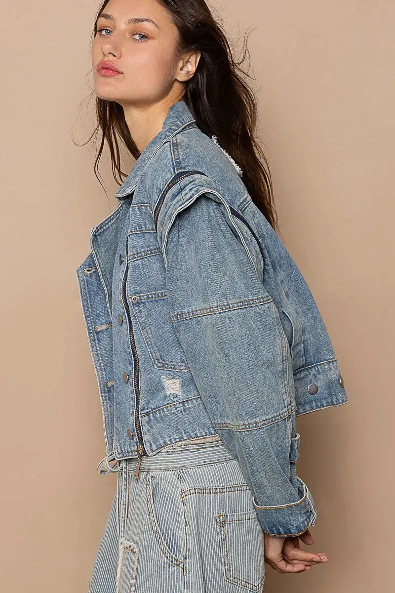 This fashion oversized cropped denim jacket features a vintage-inspired design with premium cotton denim construction. The jacket showcases a relaxed fit with dropped shoulders and a cropped hemline that pairs perfectly with high-waisted bottoms. Multiple zipper accents add edgy detail while the classic blue wash provides versatile styling options. The structured collar and lapels create a sophisticated silhouette, making it ideal for layering over casual outfits or dressing up everyday looks.