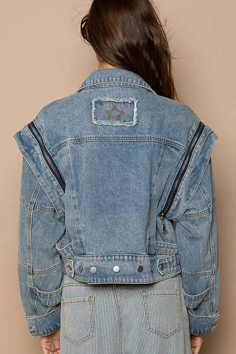 This fashion oversized cropped denim jacket features a vintage-inspired design with premium cotton denim construction. The jacket showcases a relaxed fit with dropped shoulders and a cropped hemline that pairs perfectly with high-waisted bottoms. Multiple zipper accents add edgy detail while the classic blue wash provides versatile styling options. The structured collar and lapels create a sophisticated silhouette, making it ideal for layering over casual outfits or dressing up everyday looks.