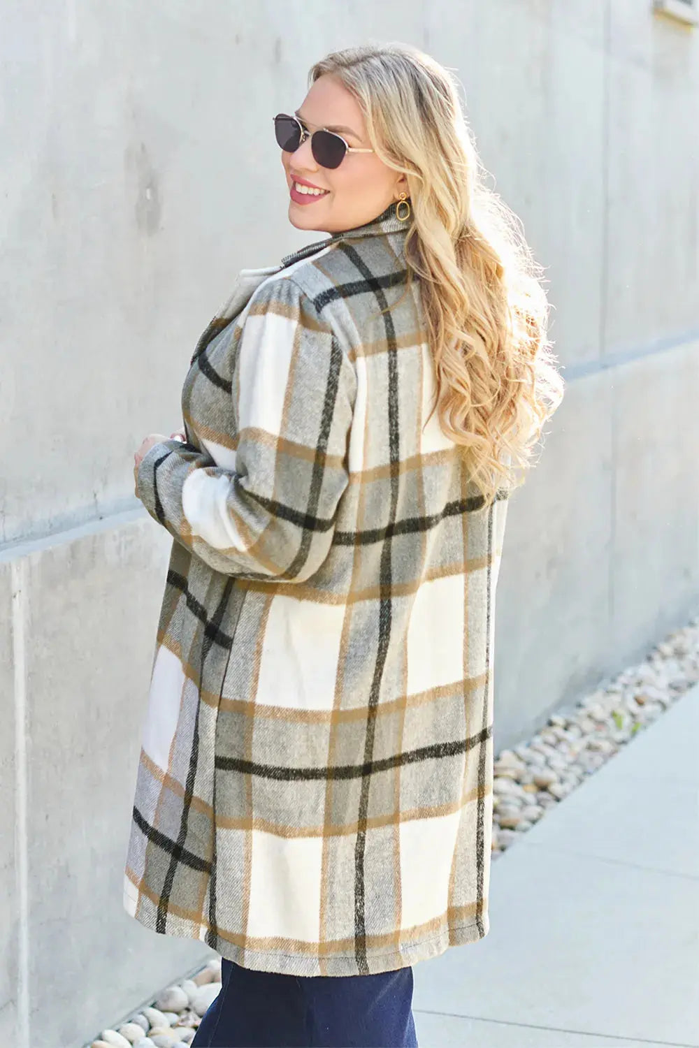 Wrap yourself in cozy charm with this Pink Plaid Button-Up Coat—a statement layer that blends warmth with playful sophistication. Designed in a soft checkered weave of blush, ivory, and brown, this midweight coat features a relaxed fit that’s perfect for layering over your everyday essentials. Classic button-front detailing and side pockets offer practicality, while the longline silhouette adds a modern, polished finish. Whether you're strolling downtown or escaping to a weekend cabin, this piece brings tex