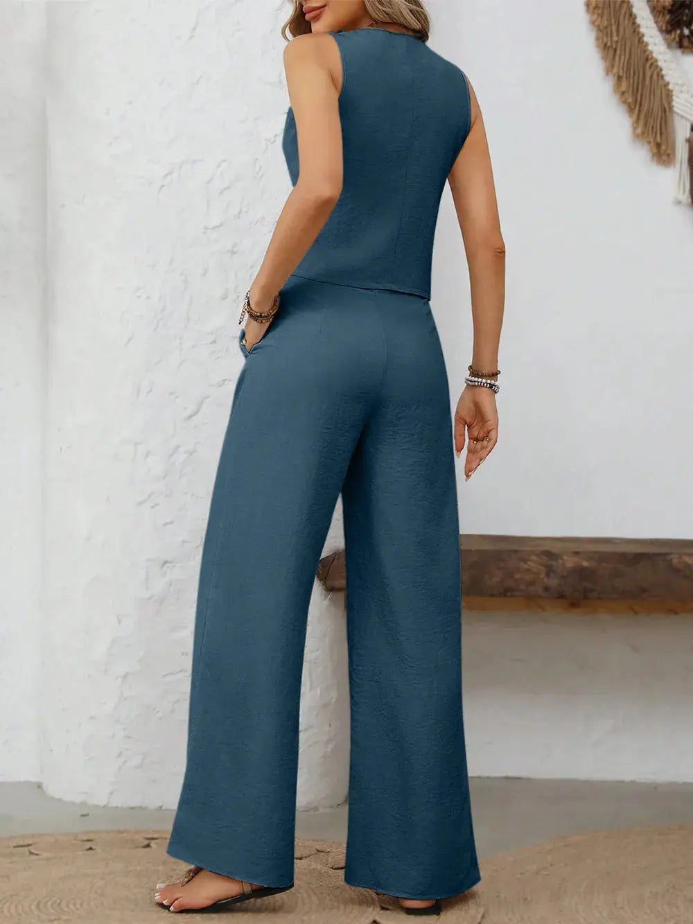Crafted in versatile shades like beige, slate gray, and soft blue, this ensemble invites endless styling possibilities. Whether layered over a crisp white shirt or styled solo for a minimalist mood, each piece adds depth to your wardrobe staples. The high-waisted pants elongate the frame, while their gentle drape moves gracefully with every step.