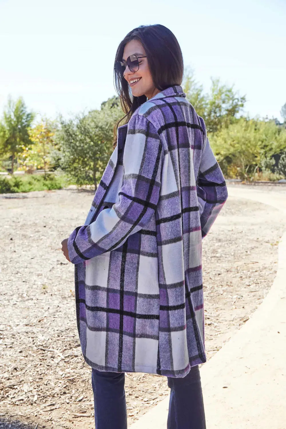 Wrap yourself in cozy charm with this Pink Plaid Button-Up Coat—a statement layer that blends warmth with playful sophistication. Designed in a soft checkered weave of blush, ivory, and brown, this midweight coat features a relaxed fit that’s perfect for layering over your everyday essentials. Classic button-front detailing and side pockets offer practicality, while the longline silhouette adds a modern, polished finish. Whether you're strolling downtown or escaping to a weekend cabin, this piece brings tex