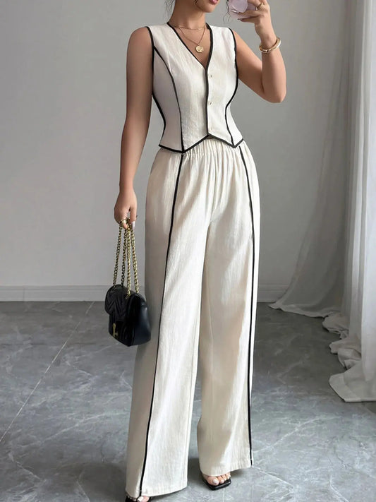 Elevate your everyday wardrobe with this contrast trim V-neck vest and pants set—a polished two-piece ensemble that blends tailored structure with relaxed ease. The sleeveless vest features a deep V-neckline and crisp contrast piping, offering a modern take on classic suiting. Buttoned detailing adds a refined touch, making it perfect for both work and weekend wear.