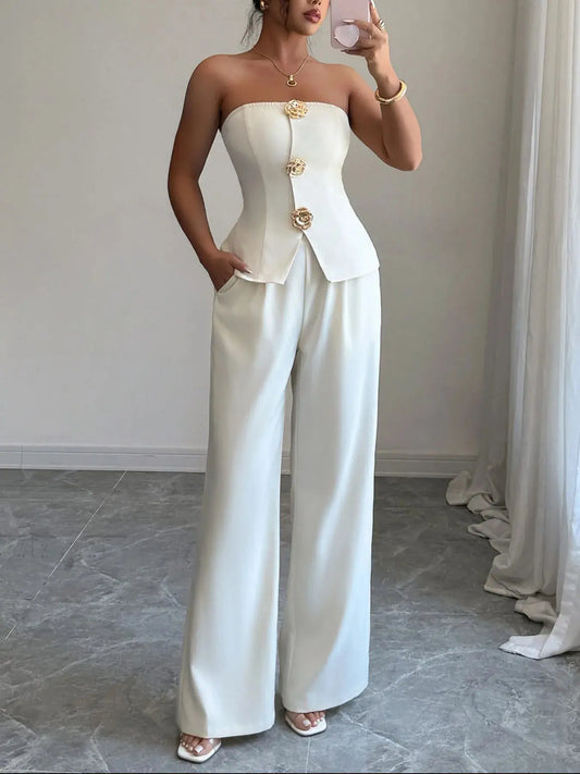 Crafted from a luxe, breathable fabric with a subtle sheen, this set balances comfort and sophistication. The wide-leg cut elongates the frame, making it ideal for heels or sleek flats. Whether you're presenting in the boardroom or sipping cocktails at a rooftop lounge, this ensemble adapts to your agenda with style.