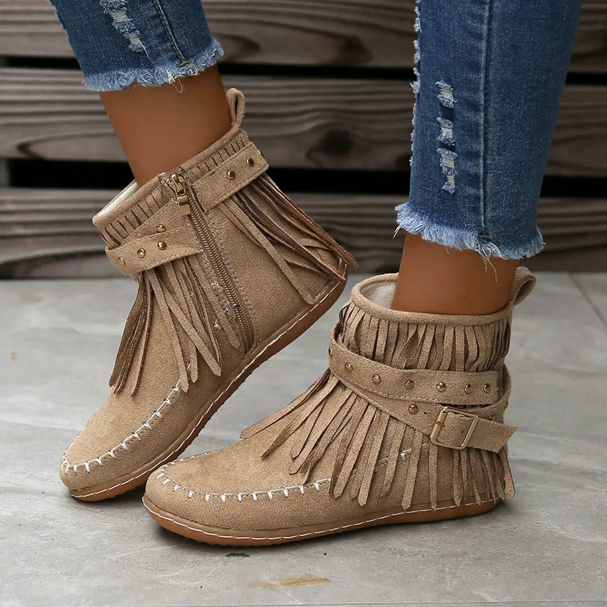 Earthy Tones set the tone for effortless style in these studded fringe suede flat boots by Grace Step. Designed to feel like a second skin, the vegan suede contours gently to your foot, creating a balanced mix of grounded elegance and playful charm. Whether dressing up denim or offsetting a neutral maxi dress, this boot adds instant personality to any look.