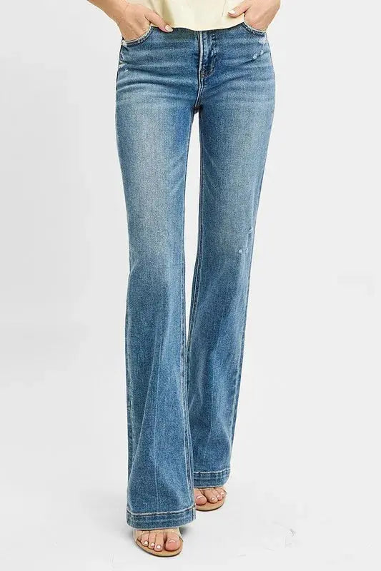 These classic blue flare leg jeans feature a high-waisted design that creates a flattering silhouette while offering a fashion retro-inspired look. Made from premium stretch denim fabric, they provide all-day comfort with a perfect fit through the hips and thighs before flaring out at the knee. The medium blue wash with subtle fading gives them a versatile appeal suitable for both casual and semi-dressy occasions. 