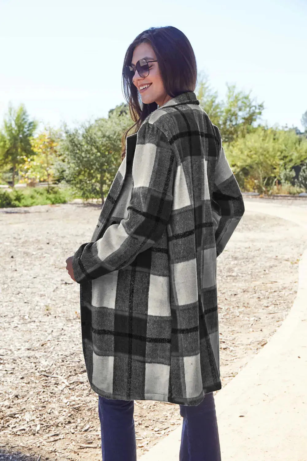 Wrap yourself in cozy charm with this Pink Plaid Button-Up Coat—a statement layer that blends warmth with playful sophistication. Designed in a soft checkered weave of blush, ivory, and brown, this midweight coat features a relaxed fit that’s perfect for layering over your everyday essentials. Classic button-front detailing and side pockets offer practicality, while the longline silhouette adds a modern, polished finish. Whether you're strolling downtown or escaping to a weekend cabin, this piece brings tex