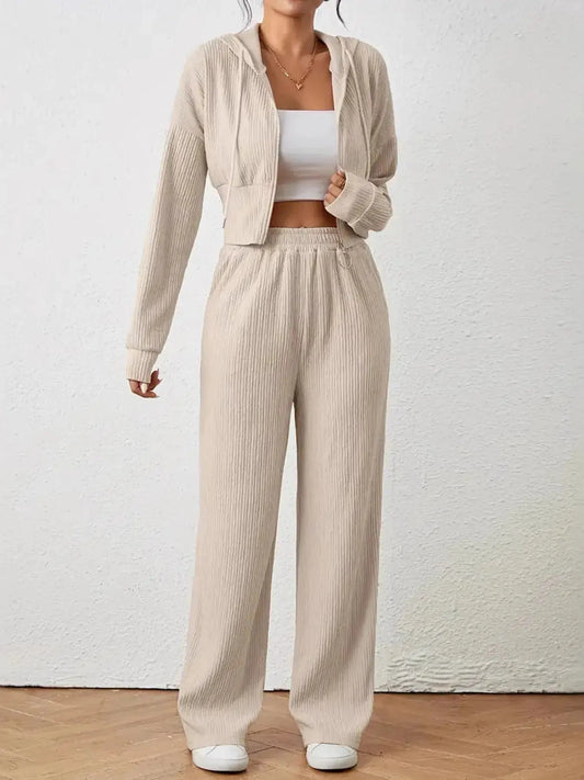 Stay effortlessly cool in this drawstring zip-up hooded top and pants set—your go-to for laid-back days and sporty style. The hoodie features a full front zip, adjustable drawstring, and a relaxed fit that layers easily over tanks or tees. With a soft, breathable fabric and functional pockets, it’s designed for comfort without compromising on edge.